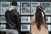People look at residential properties displayed for sale in the window of an estate agents' in London (Photo: ISABEL INFANTES/AFP via Getty Images)