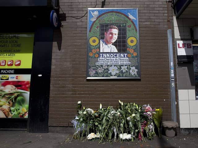 Flowers are left by a mosaic dedicated to Brazilian Jean Charles de Menezes outside Stockwell Underground Station on the tenth anniversary of his death in London on July 22 2015.
