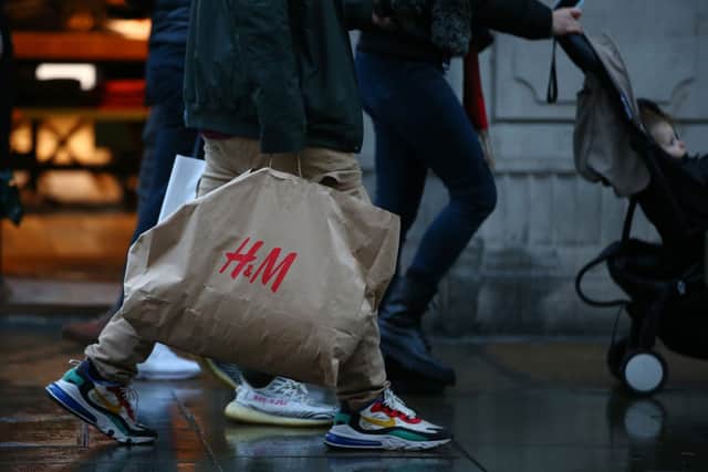 Shopper carries H&M bag.