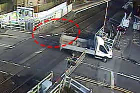 The van smashed through the level crossing barrier and dragged it along.