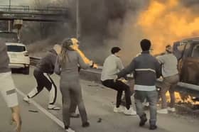 Man is pulled from burning car.