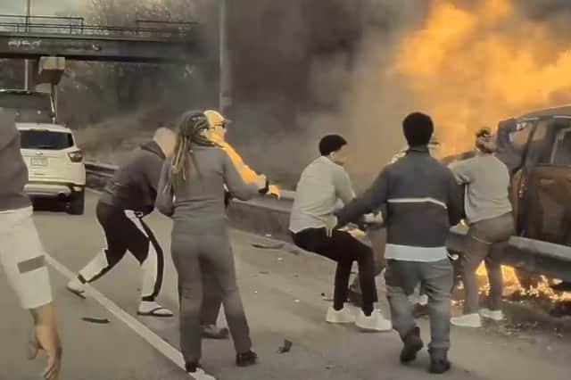 Man is pulled from burning car.
