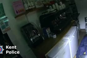 Burglar Stephen Clark found by police hiding under restaurant counter.
