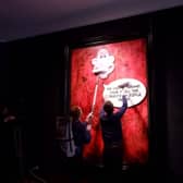 Protesters pasting over the royal portrait (Photo: Animal Rising/Supplied)