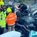 Footage of the aftermath of a car crash that left two pedestrians hospitalised shows a man being pulled from the wreckage.  
