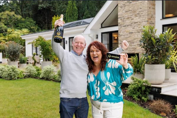 Darren & Rachael Reid - Omaze Million Pound House Surrey winners outside their new £3m home 
