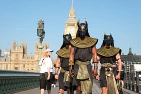 Performers dressed as the ancient Egyptian god Anubis surprise London commuters.