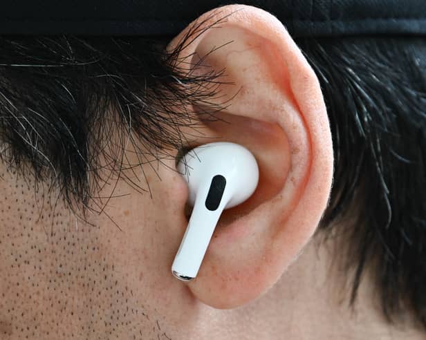 A customer wears an Apple AirPod. Photo: Patrick T. Fallon / AFP via Getty Images