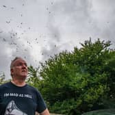 Gary Hough, 62, looks up to the skies outside his home surrounded in seagull