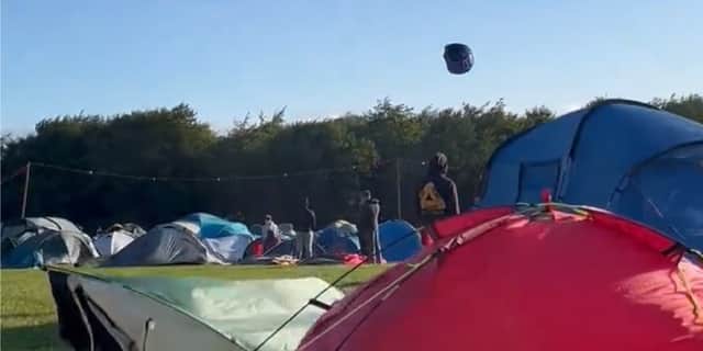 Tent hurtles across sky as Storm Lilian hits Leeds Festival.