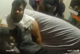 Police wake sleeping drug dealer to arrest him.