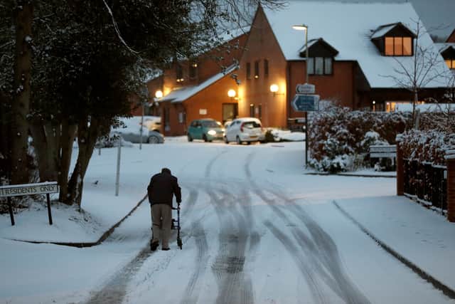 An elderly resident makes his way up a snow covered road in Hartley Wintney, in Hampshire, in 2019 (Photo: ADRIAN DENNIS/AFP via Getty Images)