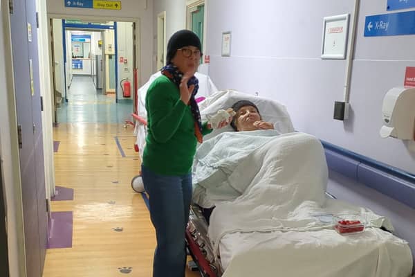 Maria Bodea, 86, and daughter Sanda as they wait in hospital corridor after Maria was admitted to hospital after a suspected heart attack.