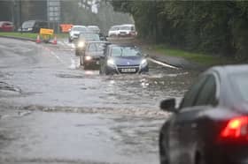 Drivers make their way through flooded roads.
