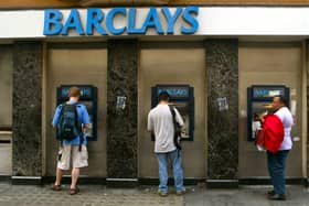 Commuters withdraw cash from ATMs outside a branch of Barclays Bank in London (Photo: Sion Touhig/Getty Images)