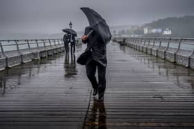 People battle against the wind and rain.