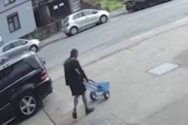 Sindeep Singh, wheeling a trolley home to transport his mother's body. 