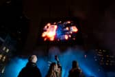 Visuals of a blue whale, northern lights, and football tricks are displayed in a hologram show over London