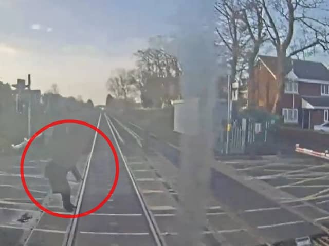 Woman comes within ‘half a second’ of being struck by train at level crossing.