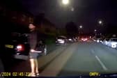 Murder victim drives away from his killer who is still grasping knife.