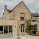 The exterior is a classic Cotswolds house, made from the local stone