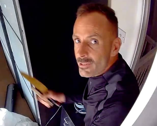 This was the moment arsonist, Martin Foley, spat in the face of a police officer as he was being rescued from a burning roof. 