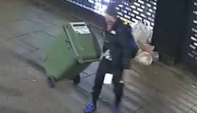 Reece Wheat drags the wheelie bin of stolen goods.