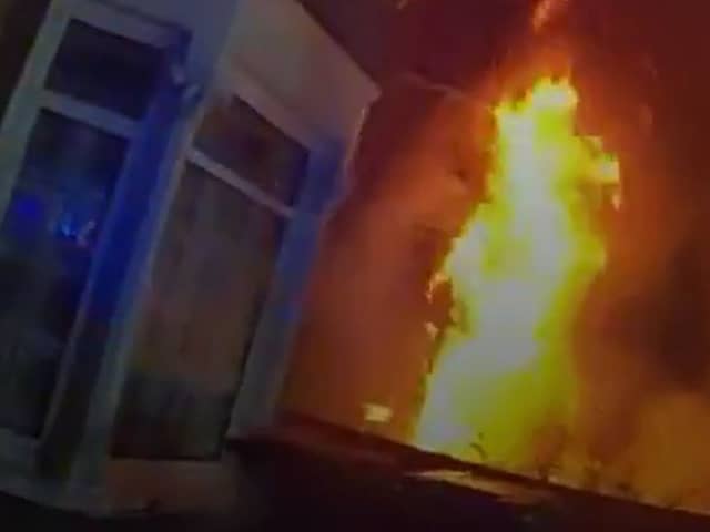 Dramatic moment massive house fire rages as police race to evacuate street.