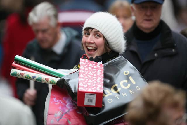 A Christmas shopper makes her away along the High Street in Bath, England. Savvy shoppers are starting their Christmas shopping earlier than ever (Photo: Matt Cardy/Getty Images)
