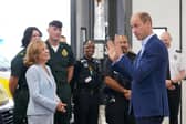 Prince William, Prince of Wales (R), with Dr Sian Williams (L), talking to staff during a visit for a previous mental health week.
