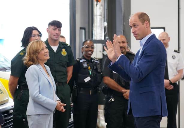 Prince William, Prince of Wales (R), with Dr Sian Williams (L), talking to staff during a visit for a previous mental health week.