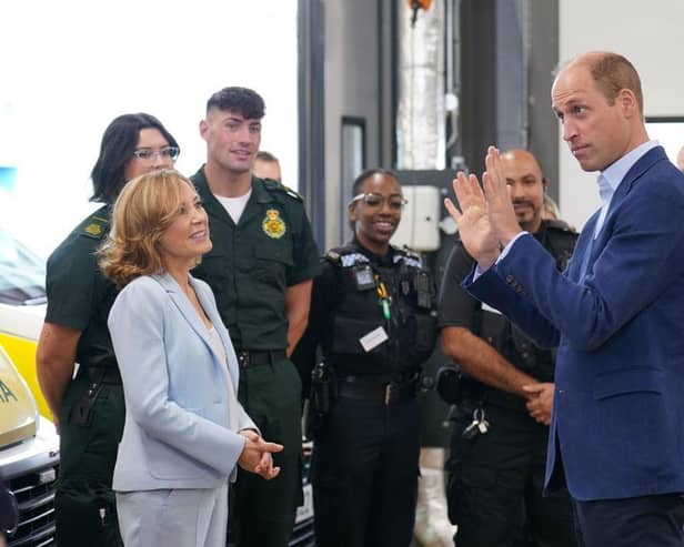 Prince William, Prince of Wales (R), with Dr Sian Williams (L), talking to staff during a visit for a previous mental health week.