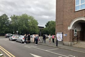 Residents protesting outside Spelthorne Borough Council with 'Stop the Boats' sign. (Credit: Emily Dalton/ LDRS)