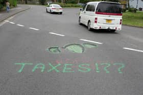 An anonymous resident spray painted potholes last year in an attempt to force the council to fix the roads. Photo: Eddie Mitchell