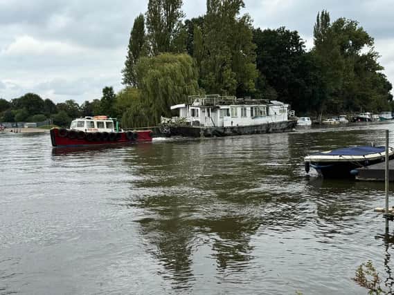 Boat being towed away by joint enforcement in Molesey, Elmbridge. (Credit: Cllr Kevin Whincup)