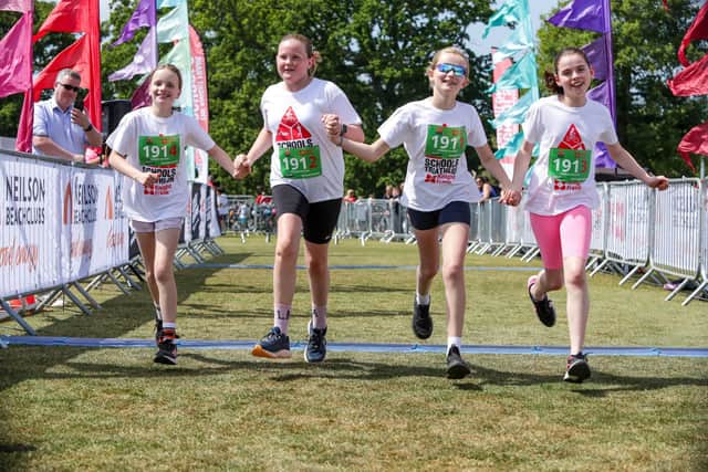 A team crossing the finish line of the Knight Frank Schools Triathlon