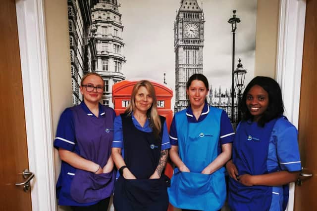 Jasmin pictured on the left with team members fashioning their new tabards