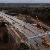 LONDON, ENGLAND - MARCH 17: In this aerial view a new gantry is installed over the M25 on March 17, 2024 in London, England. The full closure of a section of the M25 between junction 10 and 11 has taken place over the weekend to remove a bridge and install a new gantry. The closure is part of a £317m upgrade, with works expected to be finished by September. It is the first time there has been a scheduled daytime closure of all lanes of the motorway since it opened in 1986. The 117 mile long orbital motorway encircles Greater London and is the busiest in the UK. (Photo by Dan Kitwood/Getty Images)