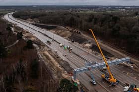 LONDON, ENGLAND - MARCH 17: In this aerial view a new gantry is installed over the M25 on March 17, 2024 in London, England. The full closure of a section of the M25 between junction 10 and 11 has taken place over the weekend to remove a bridge and install a new gantry. The closure is part of a £317m upgrade, with works expected to be finished by September. It is the first time there has been a scheduled daytime closure of all lanes of the motorway since it opened in 1986. The 117 mile long orbital motorway encircles Greater London and is the busiest in the UK. (Photo by Dan Kitwood/Getty Images)