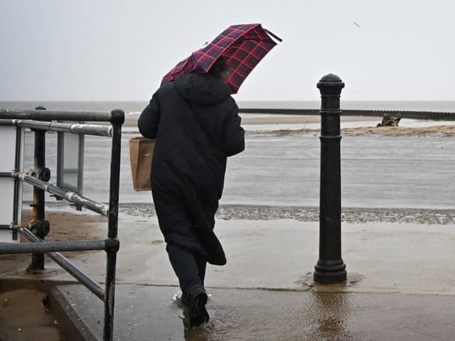 The Met Office has issued amber and yellow warnings for rain and wind across the UK this weekend. (Photo by PAUL ELLIS/AFP via Getty Images)