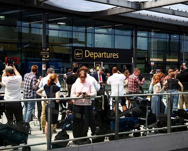 Members of the press gather outside the North terminal upper forecourt in front of the departure entrance at Gatwick Airport, south of London, in June 12, 2025 after a London-bound passenger jet with 242 people aboard crashed shortly after takeoff from India's Ahmedabad airport. Air India's flight 171 -- a Boeing 787-8 Dreamliner bound for London's Gatwick Airport, crashed shortly after takeoff around 1:40 pm (0810 GMT), officials said. The passengers included 169 Indian nationals, 53 British, seven Portuguese, and a Canadian. Two pilots and 10 cabin crew were also aboard. Indian police in the city of Ahmedabad said no survivors were expected. (Photo by HENRY NICHOLLS / AFP) (Photo by HENRY NICHOLLS/AFP via Getty Images)