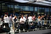 Members of the press gather outside the North terminal upper forecourt in front of the departure entrance at Gatwick Airport, south of London, in June 12, 2025 after a London-bound passenger jet with 242 people aboard crashed shortly after takeoff from India's Ahmedabad airport. Air India's flight 171 -- a Boeing 787-8 Dreamliner bound for London's Gatwick Airport, crashed shortly after takeoff around 1:40 pm (0810 GMT), officials said. The passengers included 169 Indian nationals, 53 British, seven Portuguese, and a Canadian. Two pilots and 10 cabin crew were also aboard. Indian police in the city of Ahmedabad said no survivors were expected. (Photo by HENRY NICHOLLS / AFP) (Photo by HENRY NICHOLLS/AFP via Getty Images)