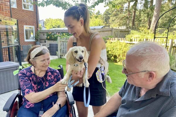 Ralph and owner Millie meeting residents of the home during the Canine Cafe