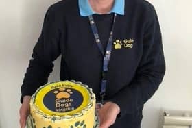 Sandi Johnson stands with a Guide Dogs cake.