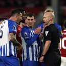 Lewis Dunk of Brighton & Hove Albion talks to Referee, Anthony Taylor during the Premier League match between Nottingham Forest and Brighton & Hove Albion at City Ground on November 25, 2023 in Nottingham, England. (Photo by Eddie Keogh/Getty Images)