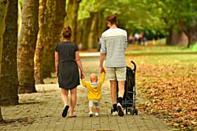 Family walking through a park, stock photo. (Credit: MabelAmber/Pixabay)