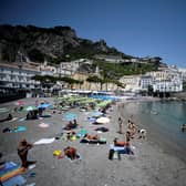 A view taken on July 2, 2020 shows tourist and residents sunbathing and swimming at a beach in Amalfi on the Amalfi coast in southern Italy. Picture by FILIPPO MONTEFORTE/AFP via Getty Images