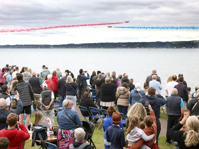 The Red Arrows dazzle spectators with their diamond nine aerobatic display across the shores of Belfast Lough