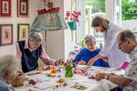 Tapestry Day Club guests enjoy creating cards with flowers from their host's garden