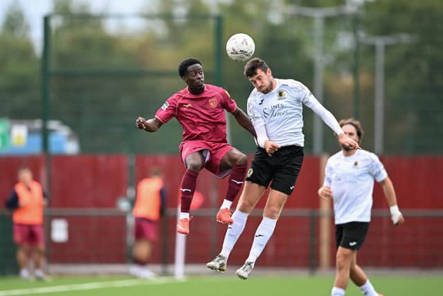 Ashley Nadesan goes airborne during Horsham's FA Cup clash at Walton & Hersham in September. Picture by McCartney Martin